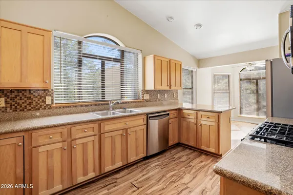 a kitchen with granite countertop a sink and a stove