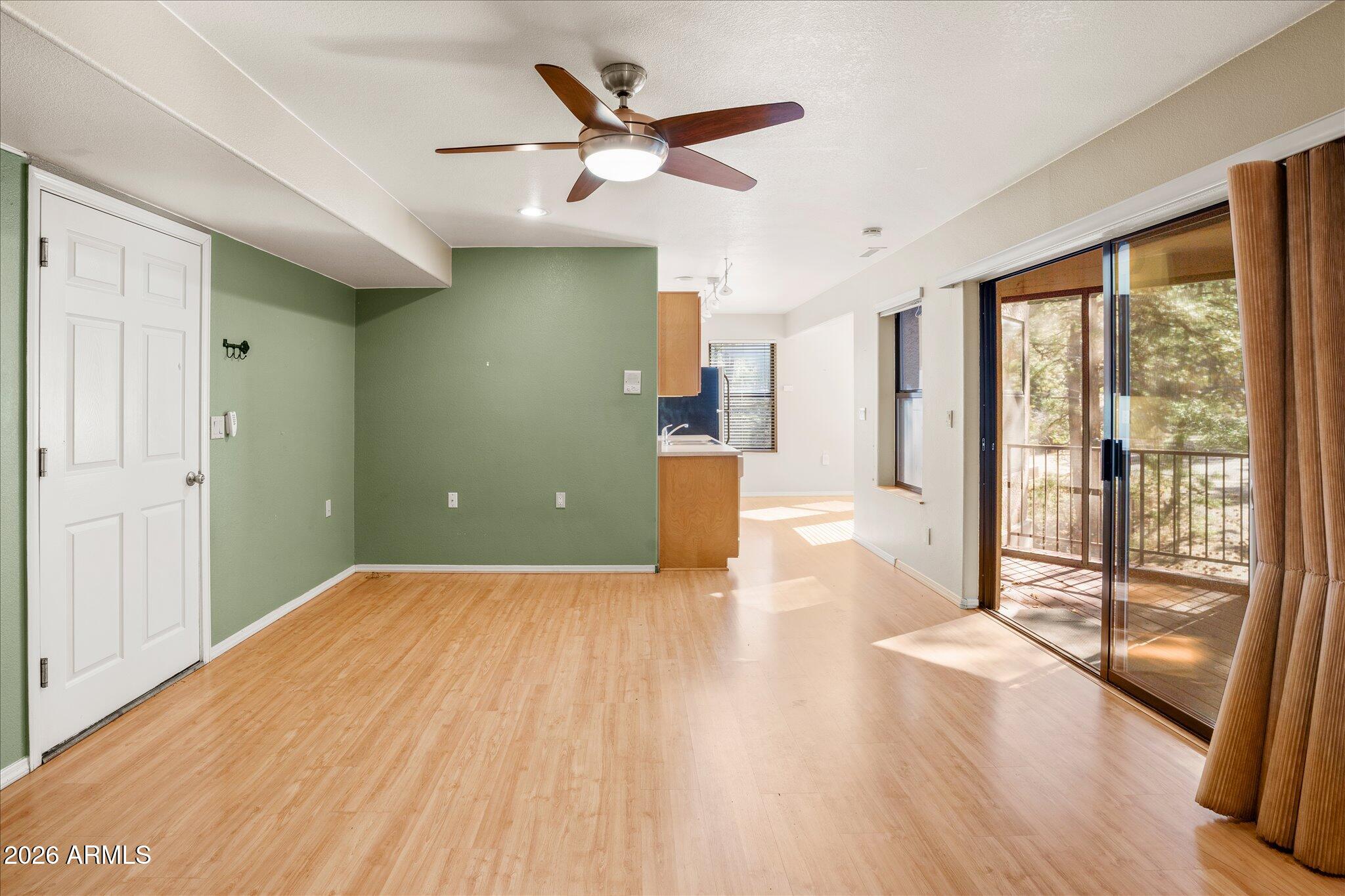 1466 East Valley View Road Prescott, AZ 86303 - Photo 25 of 31 a view of a livingroom with wooden floor and a ceiling fan