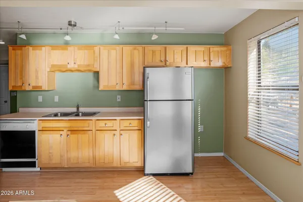 a kitchen with a refrigerator and a sink