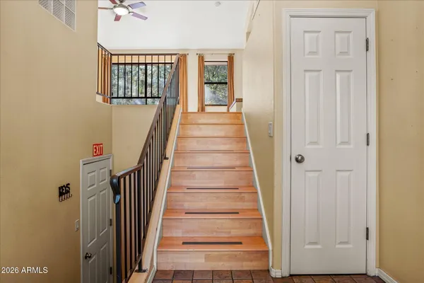 a view of a hallway with wooden floor and entryway