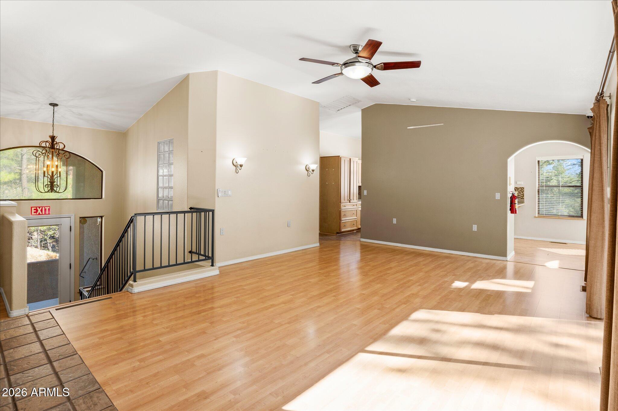 1466 East Valley View Road Prescott, AZ 86303 - Photo 8 of 31 a view of a room with wooden floor and a ceiling fan
