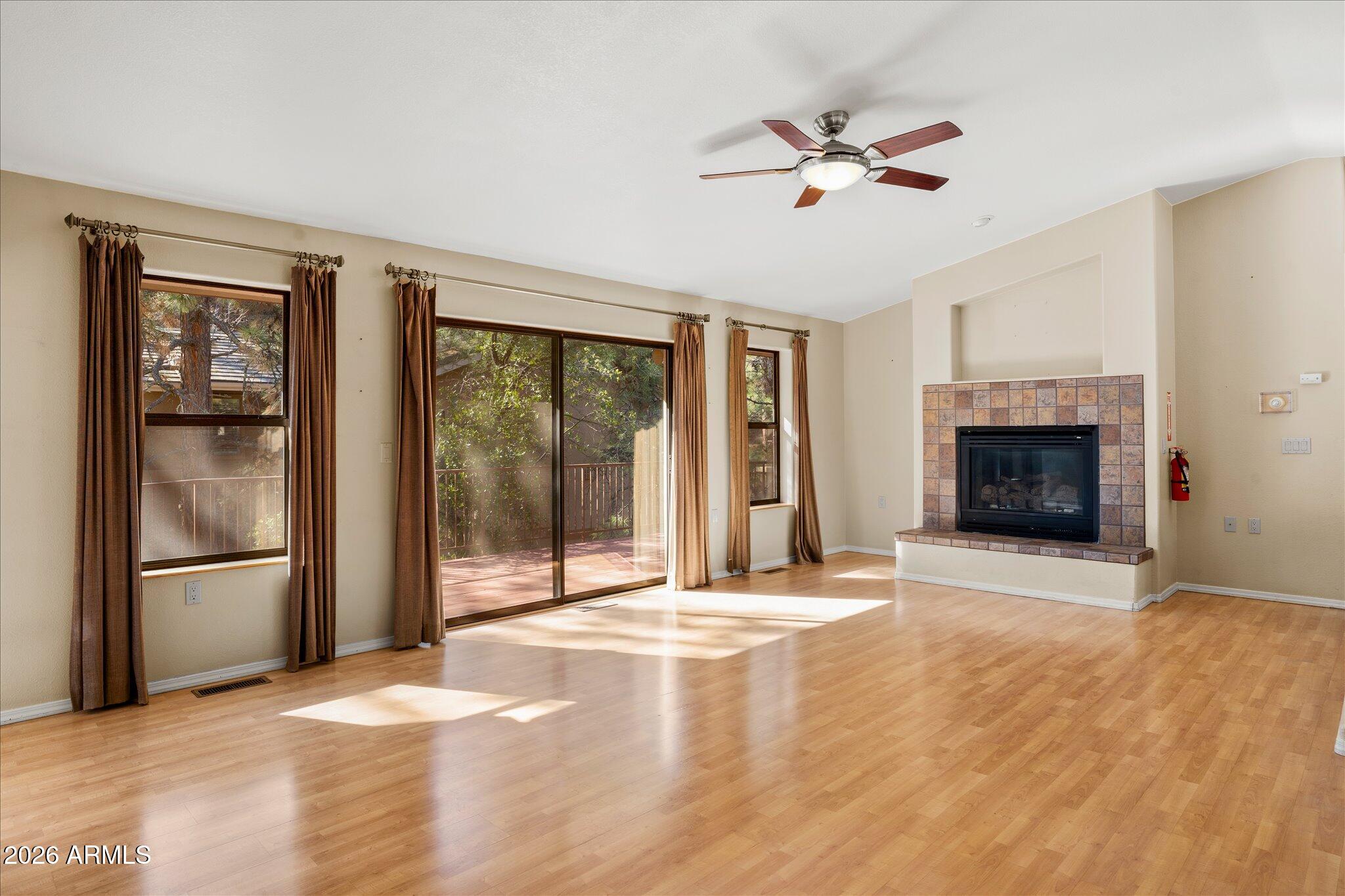 1466 East Valley View Road Prescott, AZ 86303 - Photo 9 of 31 a view of an empty room with a fireplace and a window