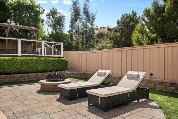 a view of a patio with chairs and plants
