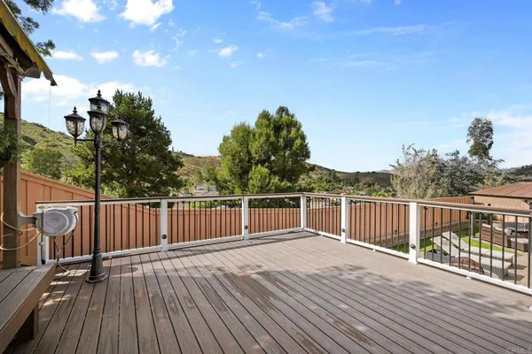 a view of a balcony with wooden floor
