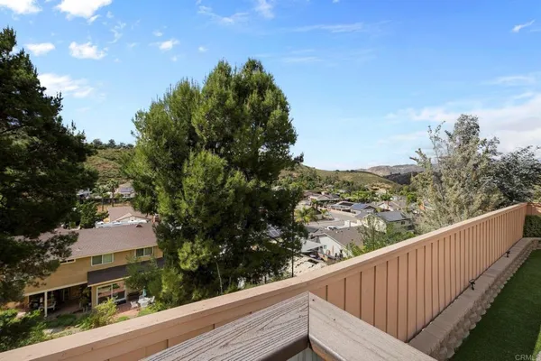 a view of a balcony with wooden fence and floor