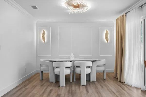 a view of a dining room with furniture and wooden floor