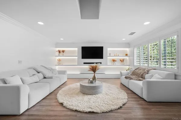 a living room with fireplace furniture and a flat screen tv