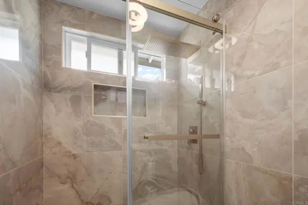a bathroom with a glass shower door