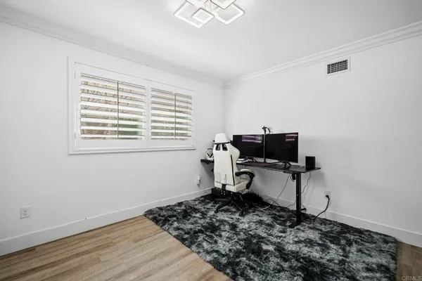 a view of a workspace with furniture and a window
