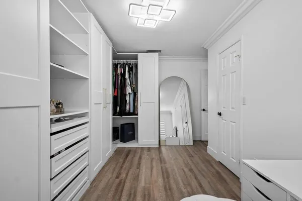 a view of walk in closet with empty racks