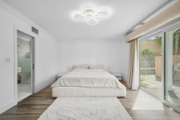 a spacious bedroom with a bed and a large window