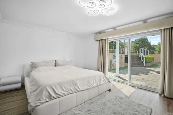 a spacious bedroom with a bed and a large window