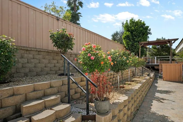 a view of a chairs and table in back yard of the house
