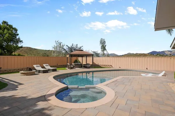 a view of a swimming pool with a table and chairs