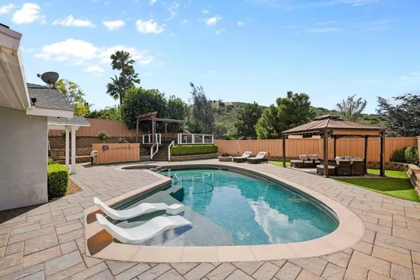 a view of a swimming pool with a patio