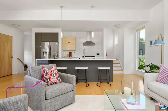 a living room with furniture and view of kitchen