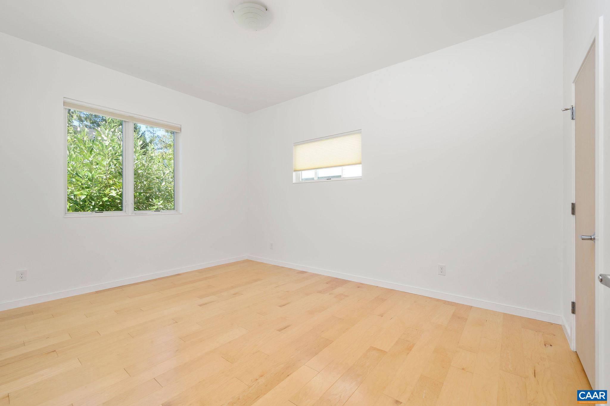 1130 East High Street, Unit J Charlottesville, VA 22902 - Photo 15 of 42 an empty room with a window