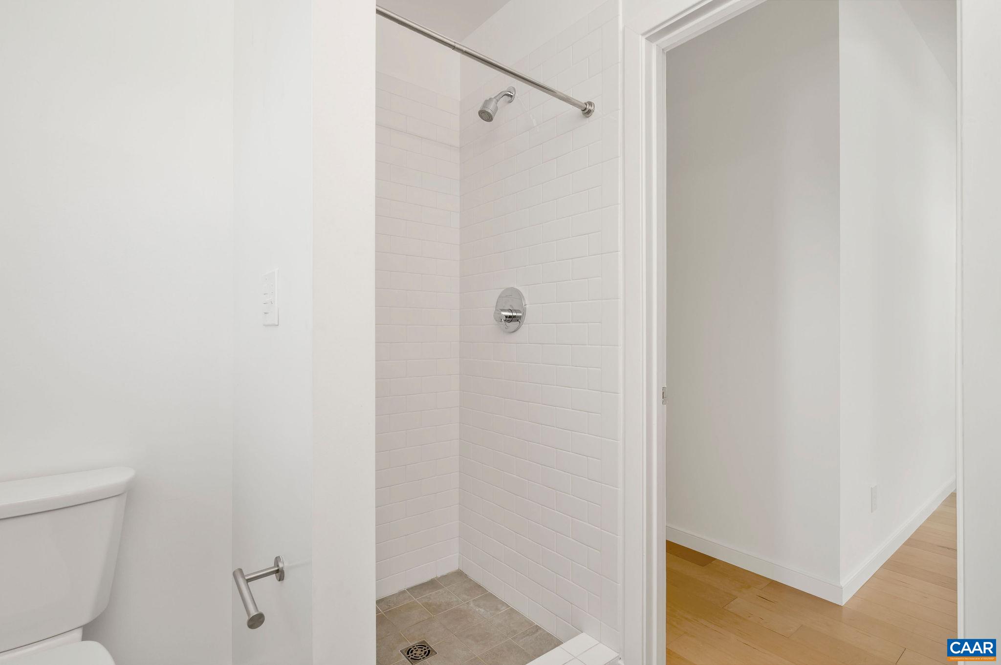 1130 East High Street, Unit J Charlottesville, VA 22902 - Photo 18 of 42 a bathroom with a shower and a toilet