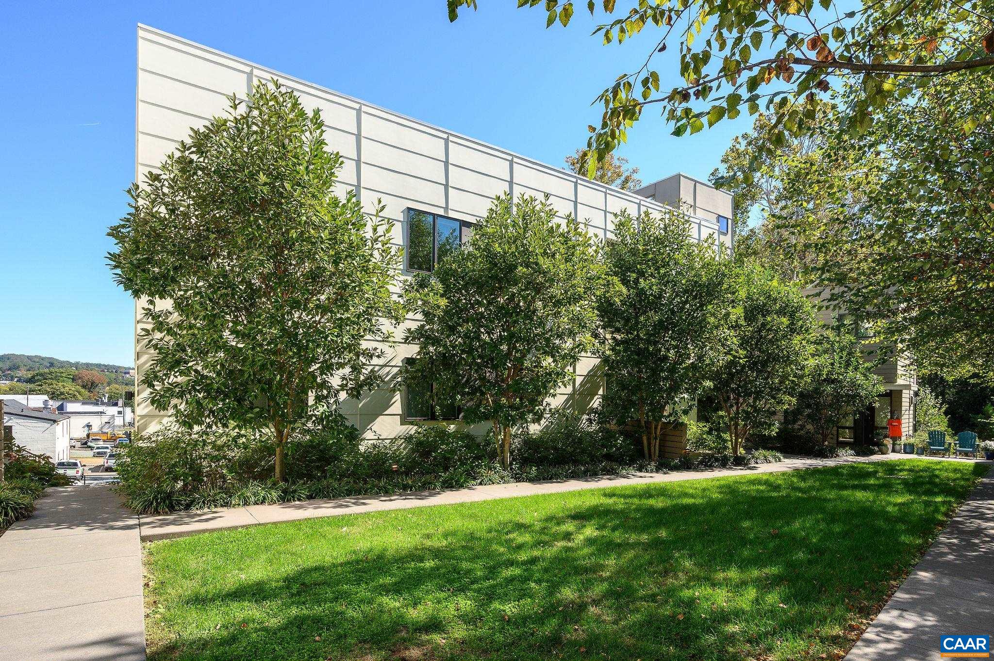 1130 East High Street, Unit J Charlottesville, VA 22902 - Photo 2 of 42 a view of a yard with a tree