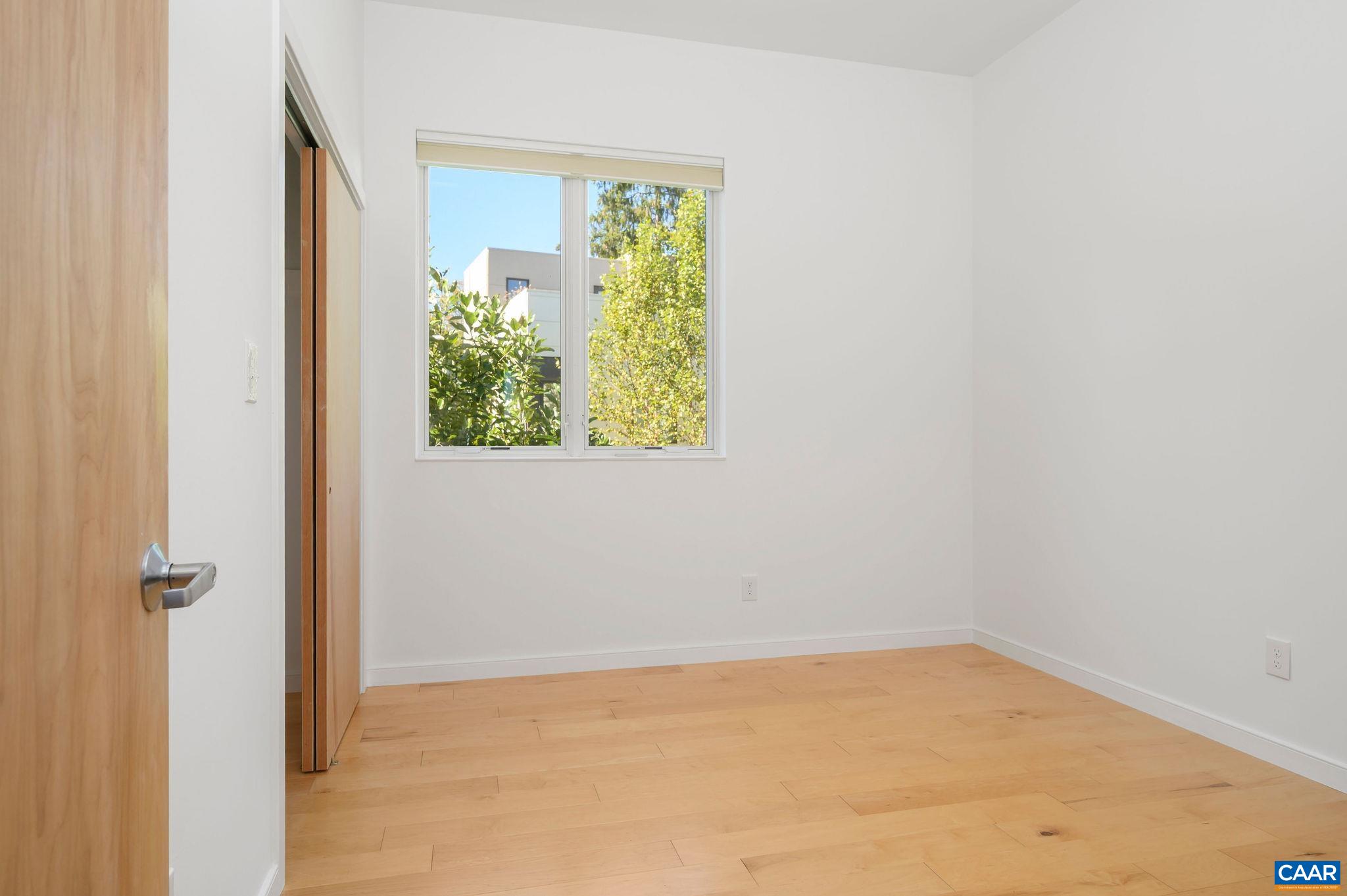1130 East High Street, Unit J Charlottesville, VA 22902 - Photo 21 of 42 an empty room with a window