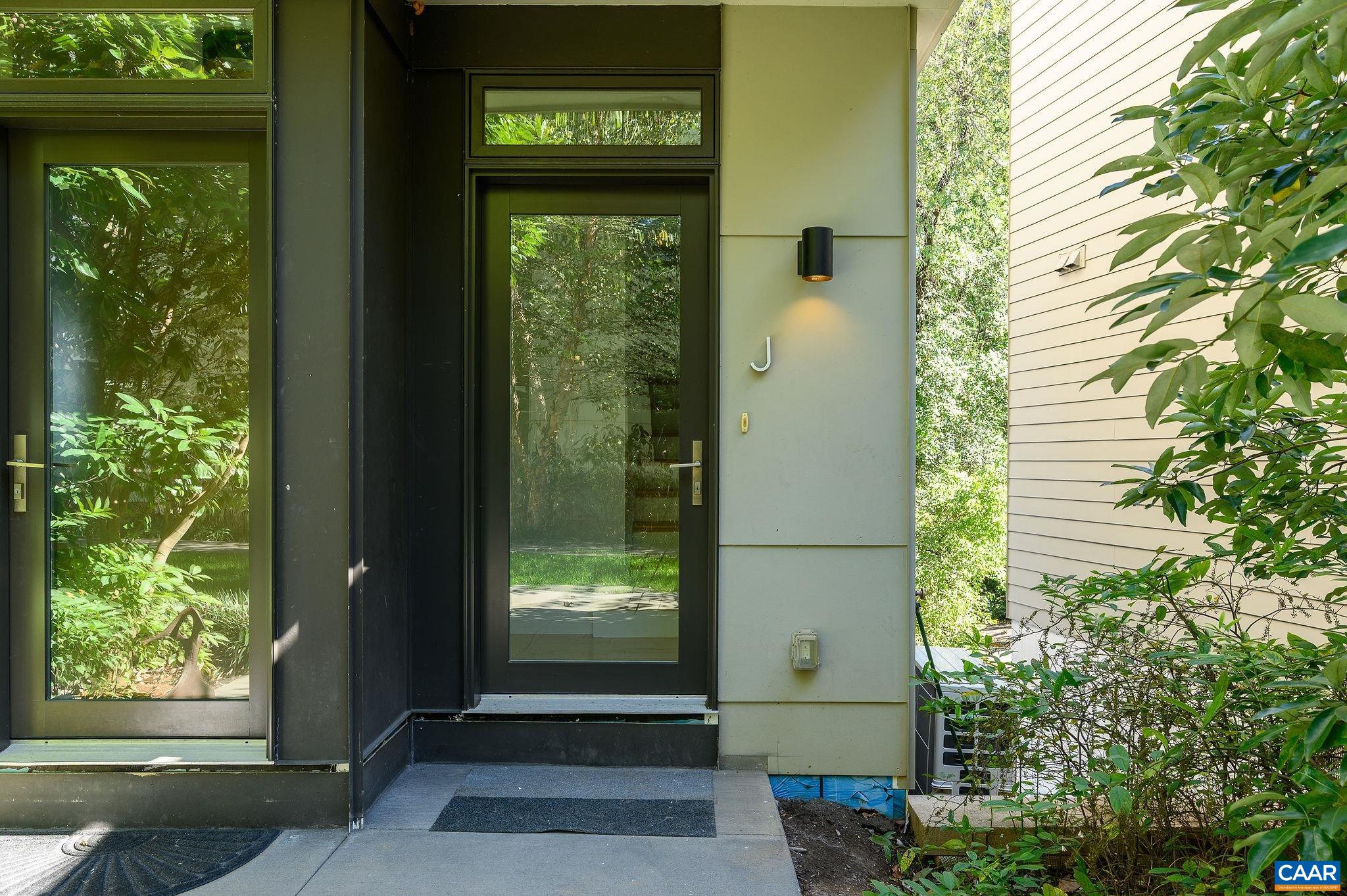 1130 East High Street, Unit J Charlottesville, VA 22902 - Photo 3 of 42 a front view of a house with a yard
