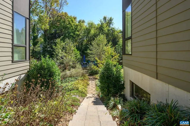 a view of a backyard with sitting area and garden