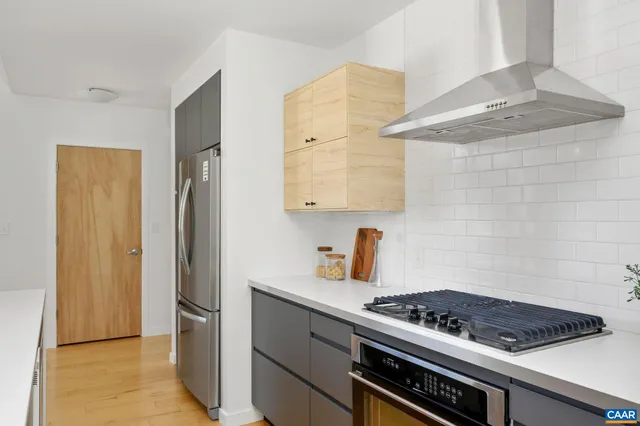 a kitchen with a stove and a refrigerator
