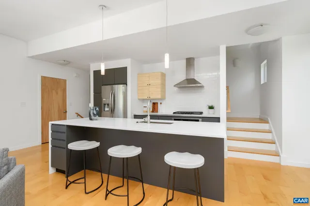 a kitchen with stainless steel appliances a sink and stove