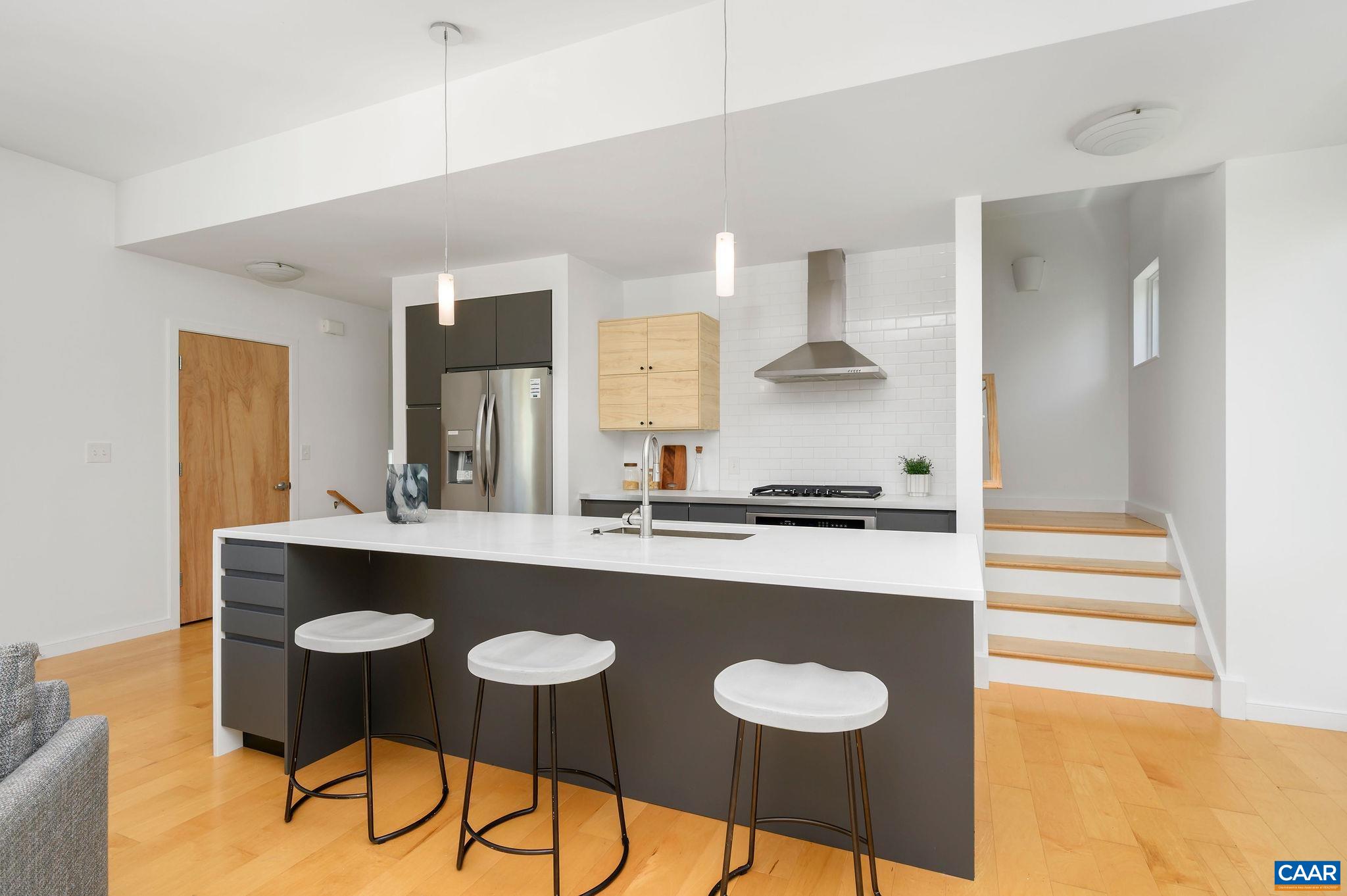 1130 East High Street, Unit J Charlottesville, VA 22902 - Photo 6 of 42 a kitchen with stainless steel appliances a sink and stove