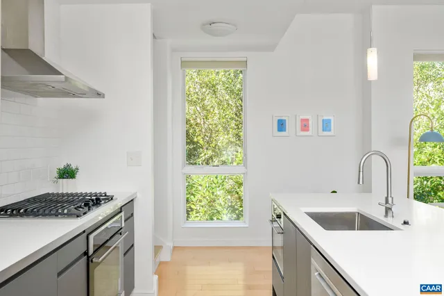 a kitchen with a sink stove and microwave