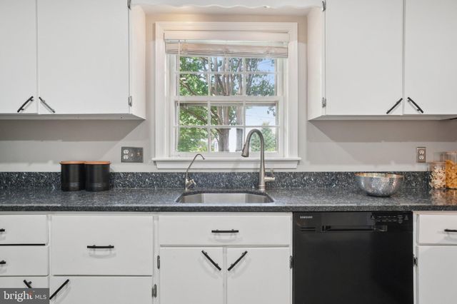 a kitchen with granite countertop a sink and a window