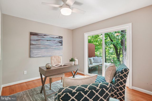 a dining room with furniture and a large window