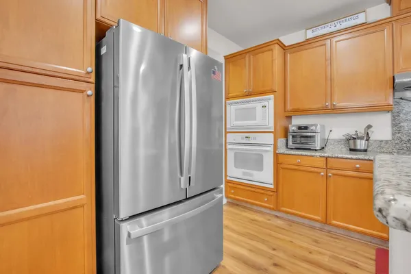 a kitchen with stainless steel appliances a refrigerator and cabinets