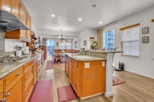 a kitchen with stainless steel appliances granite countertop a sink stove and refrigerator