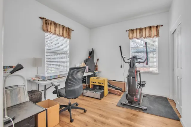 a view of a workspace with furniture and a window