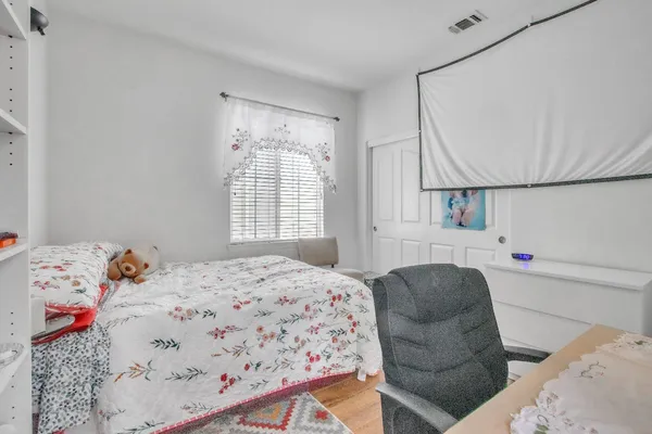 a bedroom with a bed and a window