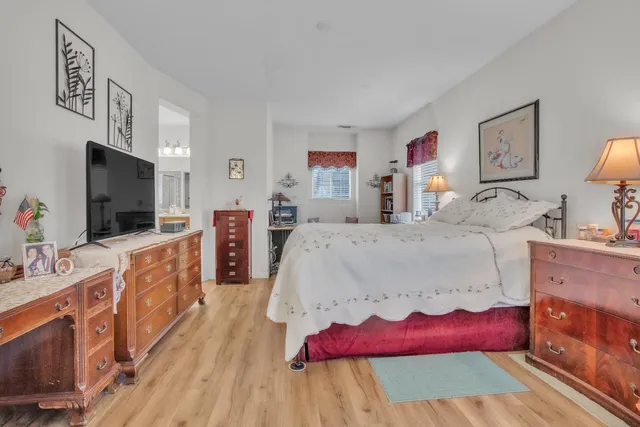 a large bedroom with a bed and a flat screen tv