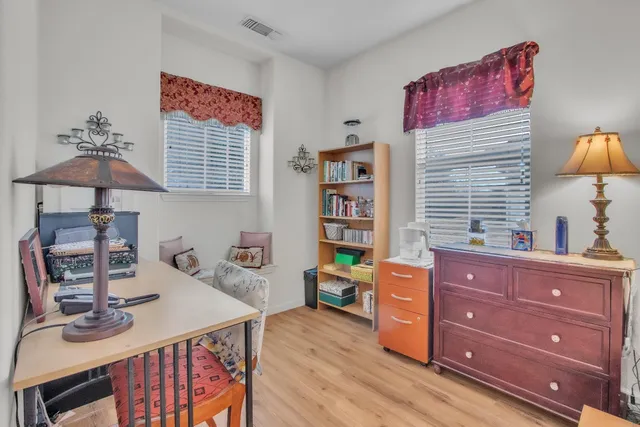 a view of a workspace with furniture and a window