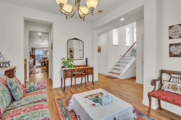 a living room with furniture and wooden floor