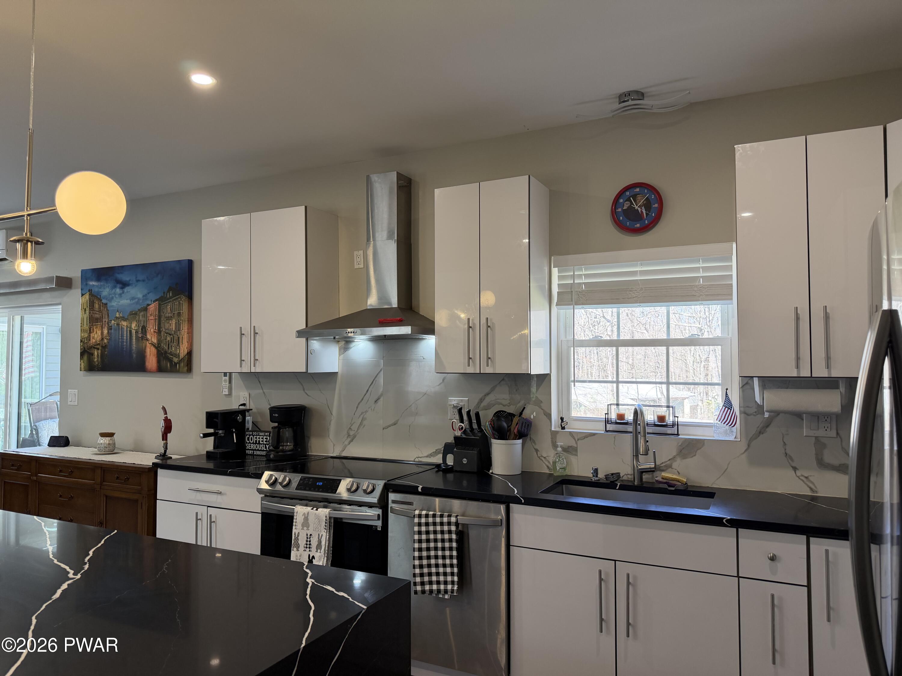 801 Maple Ridge Court Hawley, PA 18428 - Photo 18 of 55 a kitchen with granite countertop a sink cabinets and window