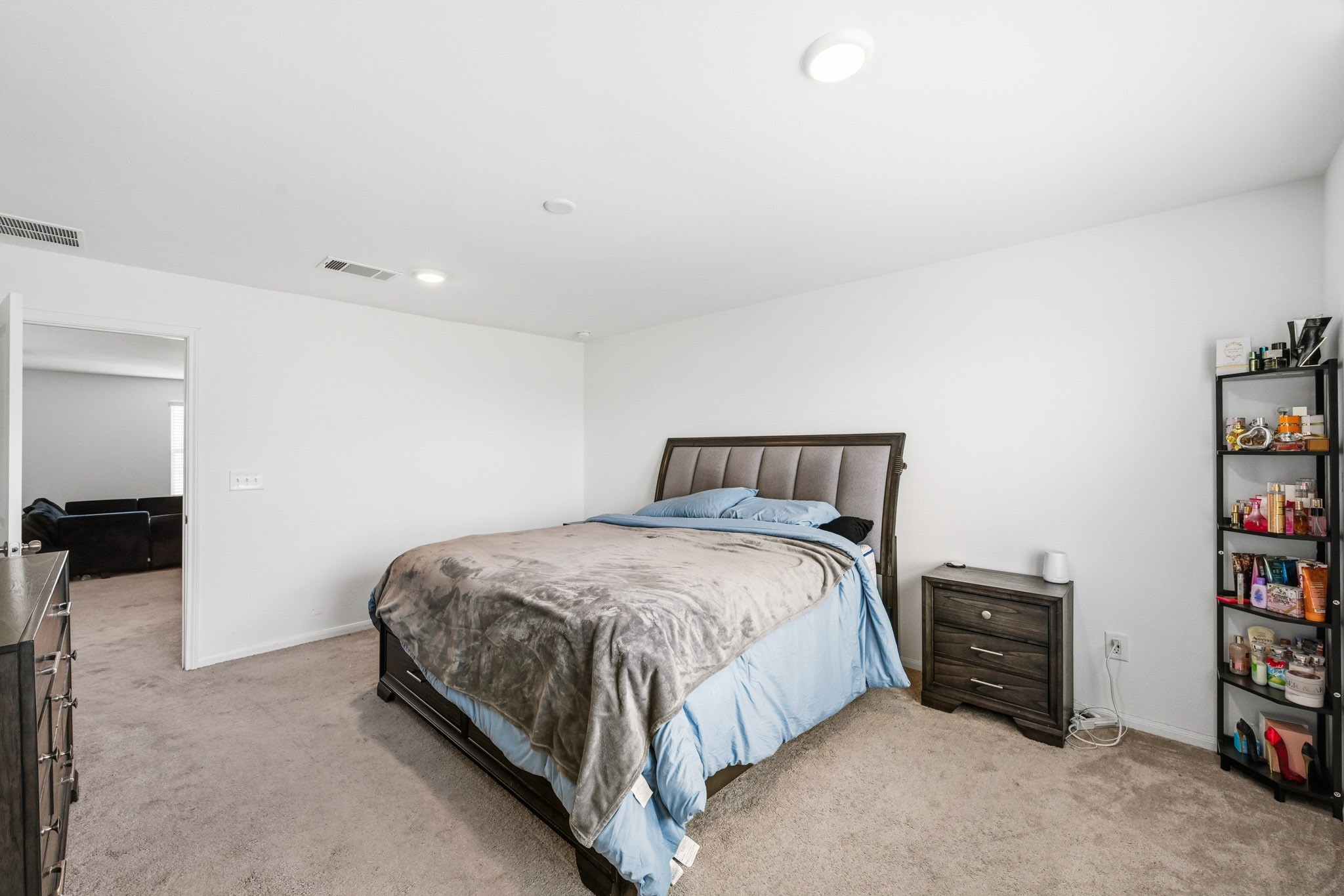 23427 Weir Box Road Hockley, TX 77447 - Photo 11 of 32 The generously sized master bedroom accommodates a king-size bed setup with ease. Offers plush neutral carpeting, bright recessed lighting, and direct access to the main living area.
