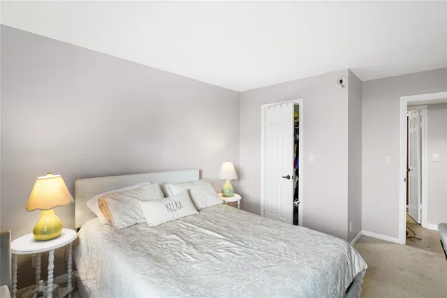 a bedroom with a bed and a lamp