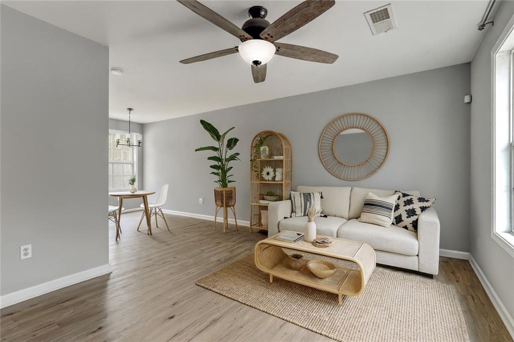 54 Taylorsville Road Aragon, GA 30104 - Photo 7 of 20 a living room with furniture a chandelier fan and a wooden floor
