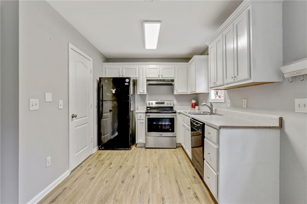 54 Taylorsville Road Aragon, GA 30104 - Photo 10 of 20 a kitchen with granite countertop a refrigerator stove top oven and sink