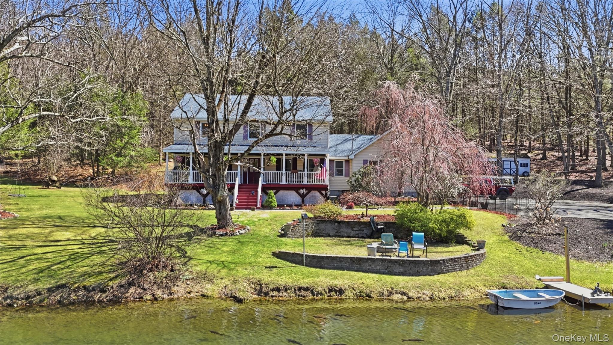 a view of a house with swimming pool and a yard