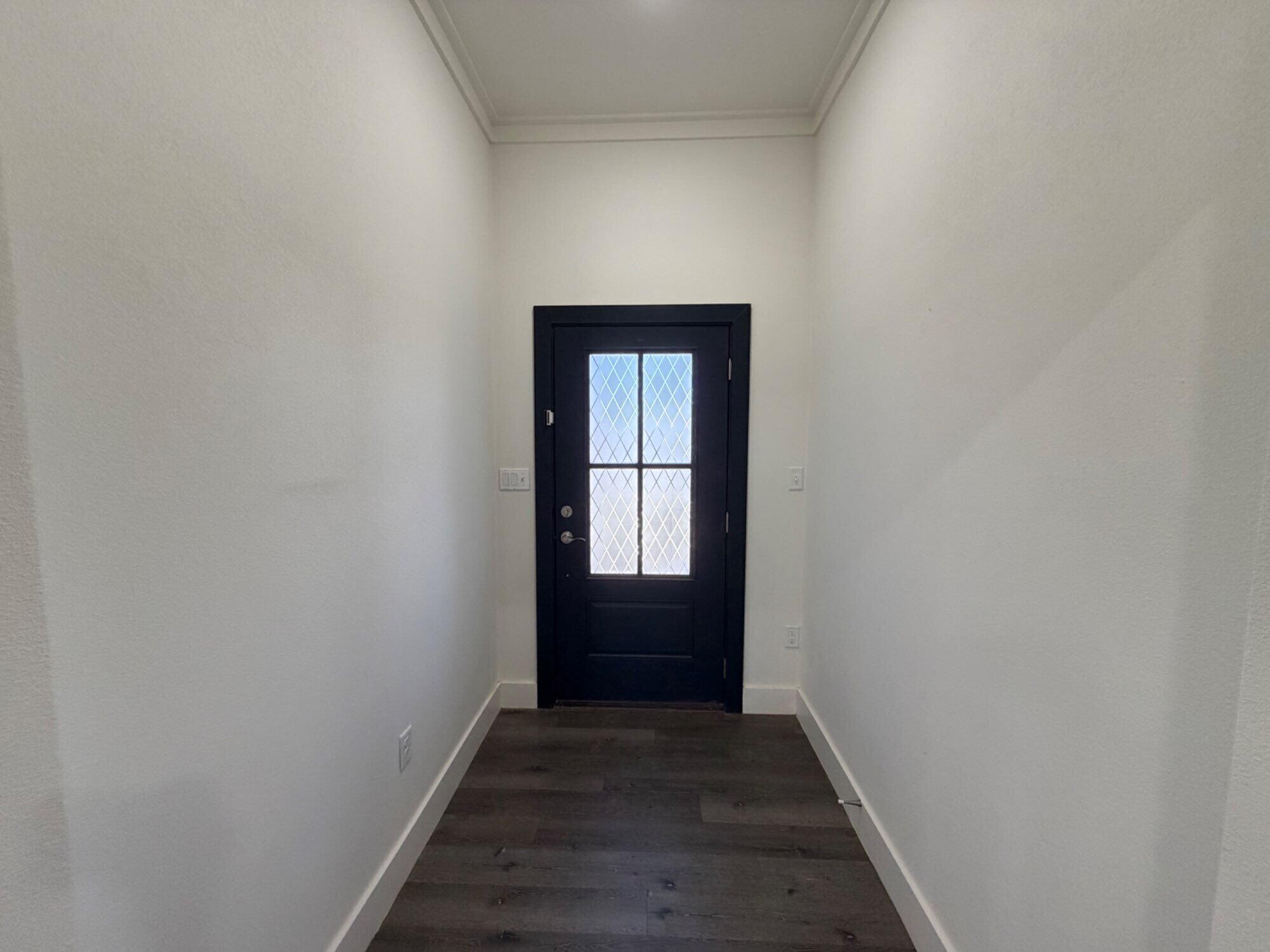 405 Ranger Street Wolfforth, TX 79382 - Photo 3 of 19 a view of an empty room with wooden floor and window