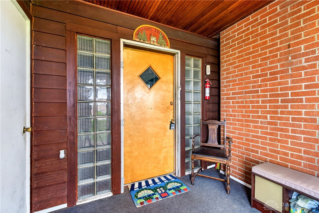 2470 Clark Run Road Xenia, OH 45385 - Photo 35 of 57 This inviting entrance features brick and wood siding, complemented by glass block window accents.