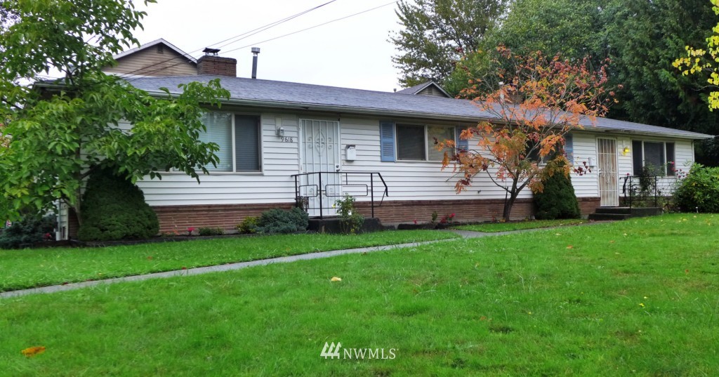 9618 Renton Avenue South Seattle, WA 98118 - Photo 1 of 7 a view of a house with a garden