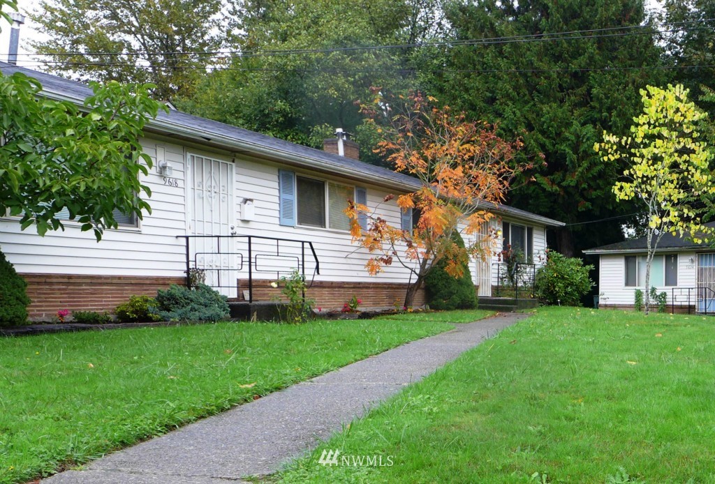 9618 Renton Avenue South Seattle, WA 98118 - Photo 3 of 7 a front view of a house with a garden and trees