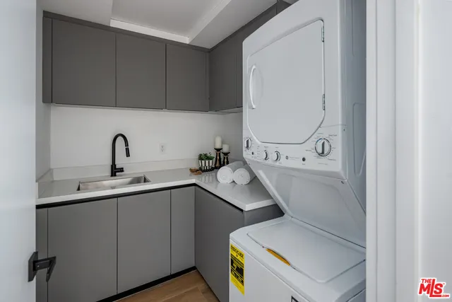 a utility room with sink dryer and washer